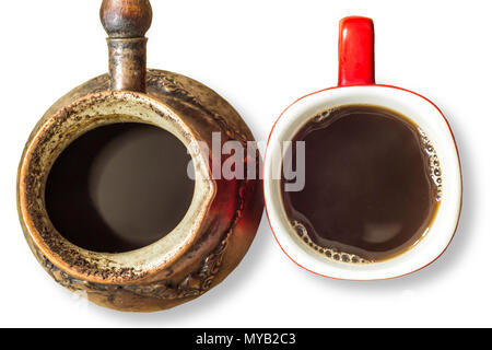An old coffee maker made in the Middle East. Coffee maker with cooked coffee and a cup of coffee.Turkish coffee .Isolated photo on a white background. Stock Photo