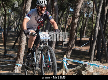 Greek male cyclist competes in an international mountain bike race in the forest course outside the Greek village of Molyvos on the island of Lesvos Stock Photo