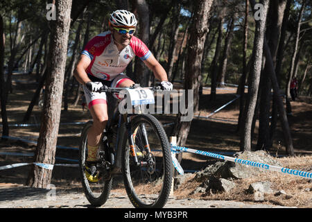 Greek male cyclist competes in an international mountain bike race in the forest course outside the Greek village of Molyvos on the island of Lesvos Stock Photo