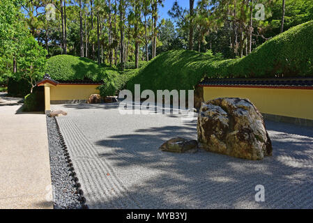 Rock garden at the Morikami Museum and Japanese Gardens, overall view with rocks, boundary wall and raked gravel, Delray Beach, FL, USA Stock Photo