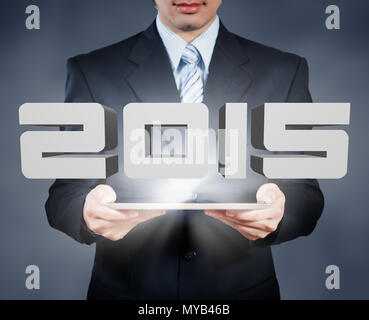 Businessman using tablet showing 2015, annual business concept Stock Photo