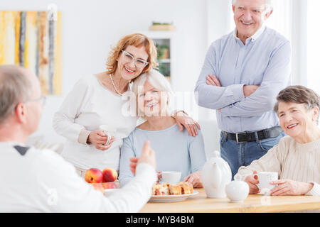Happy seniors on a meeting of old school friends Stock Photo