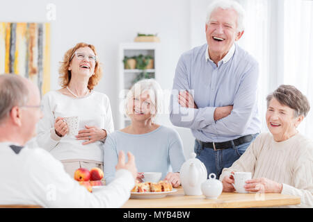 Group of happy older people laughing together on a meeting Stock Photo