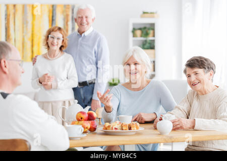 Smiling seniors having good time in nursing home Stock Photo