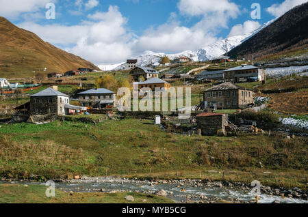 Mountain Enguri river against Caucasian Chvibiani village in Ushguli commune, Caucasus, Upper Svaneti, Georgia. Stock Photo