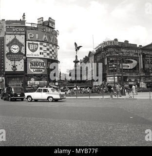 1960s, historical picture of Piccadilly Circus,  Westminster, London, England, UK, when it was a working traffic roundabout and junction. The road and public space in the centre was built in 1819 to join Piccadilly with Regent Street and is a major tourist destination in the city's West End. Some of the famous British brands of the era can be seen on the advertising billboards, which at night light up. Stock Photo