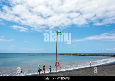 Spain, Tenerife - May 16, 2018: Green flag on the beach. Stock Photo