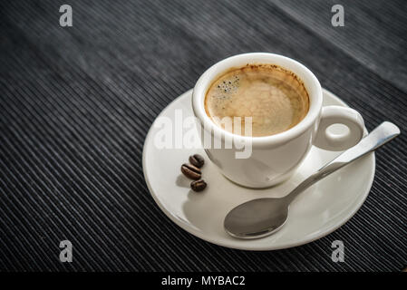 Coffee Espresso. Cup Of Coffee on textile  background closeup. Stock Photo