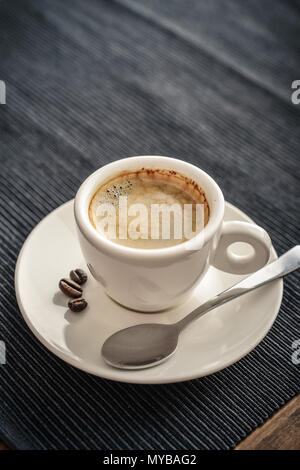 Coffee Espresso. Cup Of Coffee on textile background closeup. Stock Photo