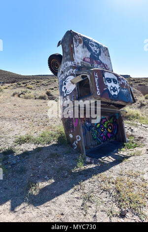 Junk car artistically buried in the desert near Goldfield Nevada Stock Photo