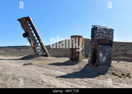Junk car artistically buried in the desert near Goldfield Nevada Stock Photo