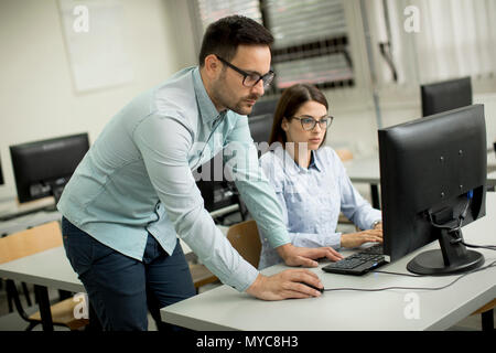 Young students presenting e-learning service in classroom Stock Photo
