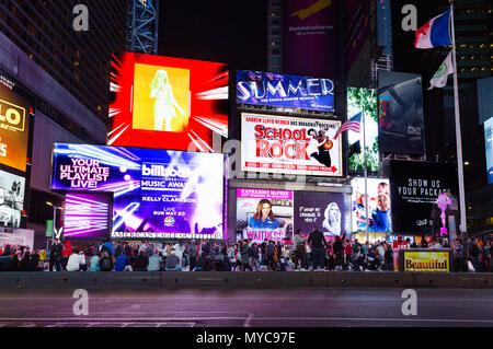 Times square Musicals advertised on neon signs colorful and brightly lit at night,  Times Square, Broadway, York city USA Stock Photo