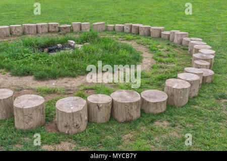 Log seating forming the 'fire circle' at an outdoors education centre. Stock Photo