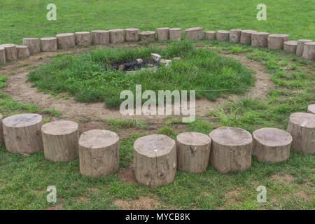 Log seating forming the 'fire circle' at an outdoors education centre. Stock Photo