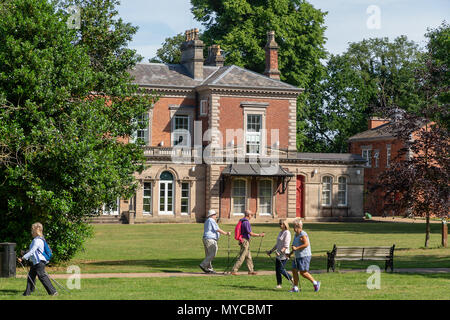 06 June 2018 - A group of elderly people practice Nordic walking along a path in the gardens of Castle Park, Frodsham, Cheshire, England, UK Stock Photo