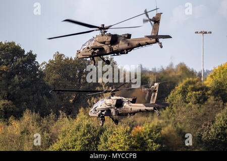 EINDHOVEN, THE NETHERLANDS - OCT 27, 2017: Two US Army Boeing AH-64D Apache attack helicopters leaving Eindhoven airbase. Stock Photo