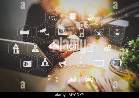 Internet of Things (IOT) technology with AR (Augmented Reality) on VR dashboard. Man using VOIP headset with digital tablet computer docking smart key Stock Photo