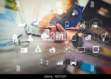 Internet of Things (IOT) technology with AR (Augmented Reality) on VR dashboard. designer hand working with digital tablet and laptop computer and boo Stock Photo