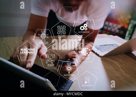Machine learning technology diagram with artificial intelligence (AI),neural network,automation,data mining in VR screen.designer using smart phone an Stock Photo