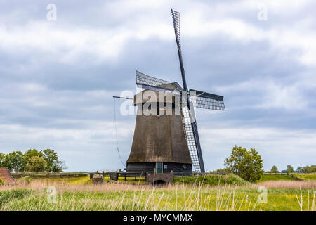 One of the many Dutch windmills that populate the fields in the center of the image. Oterleek netherlands holland Stock Photo