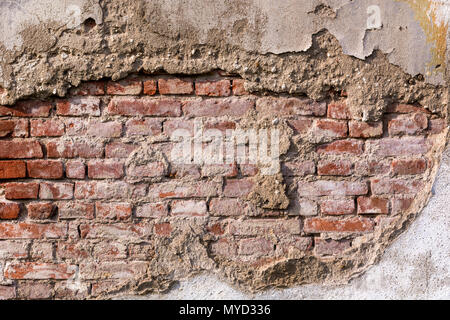 Empty very old red brick wall texture. Painted Distressed wall surface. Grunge red stonewall background. Shabby building facade with damaged plaster Stock Photo