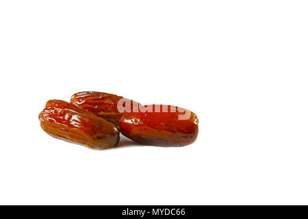Three dried date fruit on isolated white background Stock Photo
