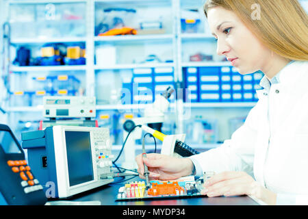Technician testing circuit in microelectronics laboratory. Stock Photo