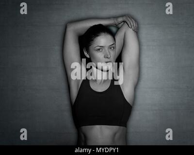 Young woman stretching arm, portrait. Stock Photo