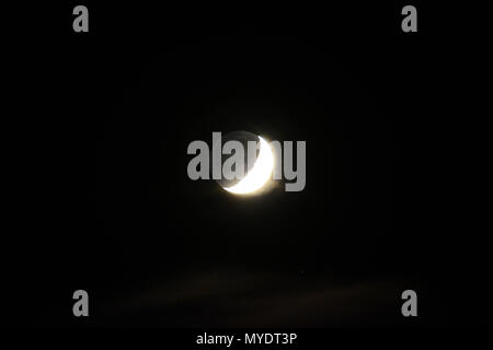 Waxing crescent moon photographed over England on a clear night in Arpil. Stock Photo