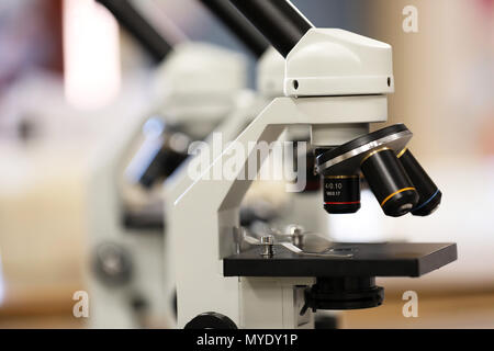 close up of a pair of electronic microscopes in a science classroom or laboratory research facility. knowledge, medicine, pathology, medical concept. Stock Photo