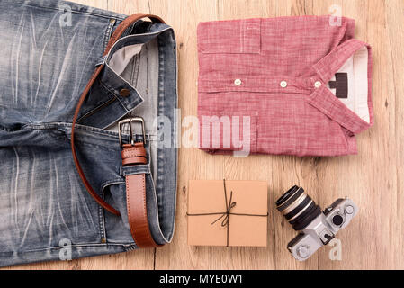 Men's beach clothes and accessories on wooden table Stock Photo - Alamy