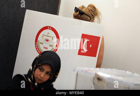 7 June 2018, Huerth, Germany: A woman stands near the ballot box at the Turkish general consulate. Turkish people living in Germany may cast their vote for the Turkish presidential and parliamentary elections from the 7th until the 19th of June. North Rhine-Westphalia has voting stations in Cologne, Essen, Duesseldorf and Muenster. Photo: Oliver Berg/dpa Stock Photo