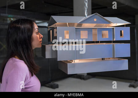 London, UK. 7th Jun, 2018. A gallery assistant views 'Mobile Homestead Swag Lamp' by Mike Kelley at the launch of an exhibition of artworks donated by internationally acclaimed artists at Cork Street gallery.  The works will be auctioned to benefit a major new fund, Artists for Artangel, allowing Artangel, the arts commissioning agency, to continue to produce extraordinary artworks in unexpected places. Credit: Stephen Chung / Alamy Live News Stock Photo