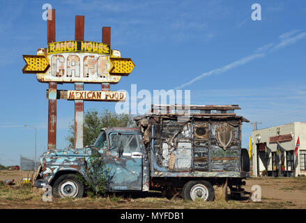 A dilapidated Chevrolet Apache truck sits in front of the rusting neon Ranch House Cafe sign in the Route 66 town of Tucumcari, New Mexico. Stock Photo