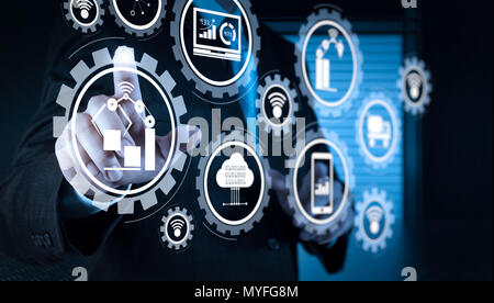 Smart factory and industry 4.0 and connected production robots exchanging data with internet of things (IoT) with cloud computing technology.businessm Stock Photo