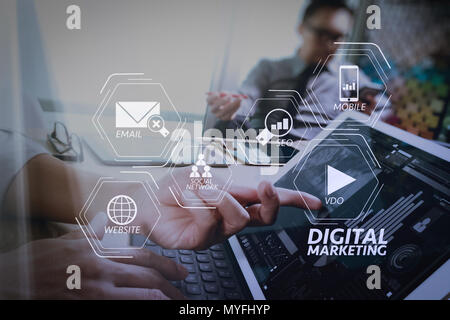 Digital marketing media (website ad, email, social network, SEO, video, mobile app) in virtual screen.Business team meeting present. Photo professiona Stock Photo