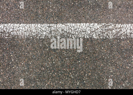 grey asphalt road texture with cracked white dividing line Stock Photo