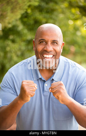 Excited African American man pumping his fist. Stock Photo