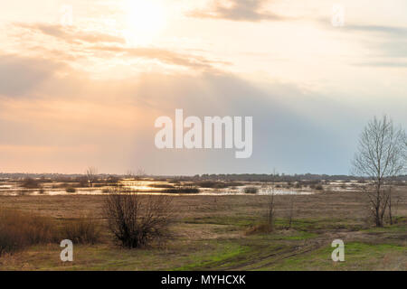 The sun shines through the rain clouds Stock Photo