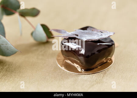 Delicious chocolates cakes. Glossy glaze and chocolate decor. small square. dessert pie for sale at the shop. Stock Photo