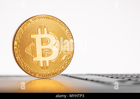 Golden Bitcoin coin on the laptop keyboard. Internet stock. Trading concept. Stock Photo