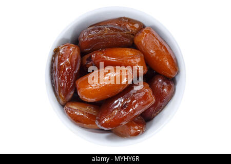 Dates fruit date from above bowl isolated on a white background Stock Photo