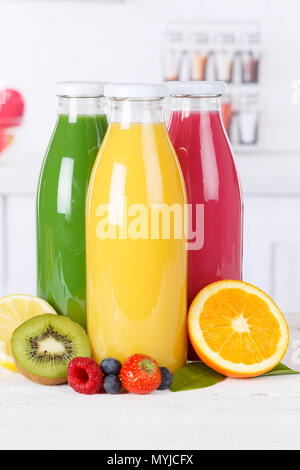 Juice smoothie orange smoothies in kitchen bottle portrait format fruit fruits fresh drink Stock Photo