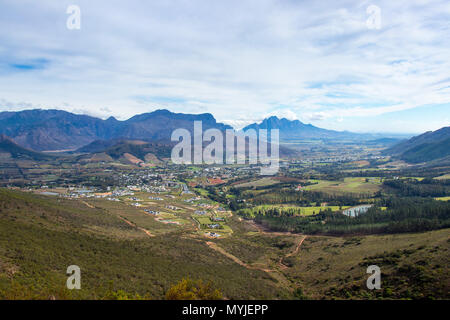 Panoramic view of town in valley with mountainous background Stock Photo