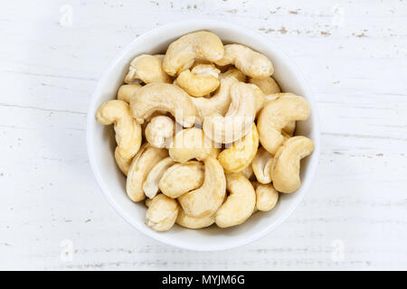 Cashew nuts cashews from above bowl wooden board wood Stock Photo