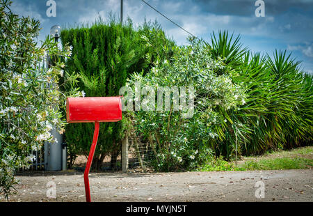 red mailbox of country house in sunny and cloudy day Stock Photo