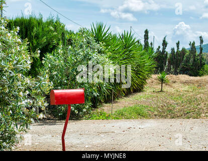 red mailbox of country house in sunny and cloudy day Stock Photo