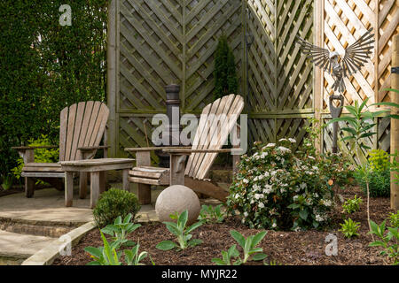 Beautiful, landscaped, private garden close-up with contemporary design, border plants, patio seating & ornamental features - Yorkshire, England, UK. Stock Photo