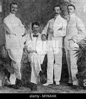 . English: Explorers and ethnographers Hiram M. Hiller, Jr. (far left), William H. Furness, III, and Alfred C. Harrison, Jr., along with Lewis Etzel, Furness' assistant. Sources appear to differ as to whether Furness or Etzel is seated. Photographed 1898 in Singapore. NOTE: The University of Pennsylvania Museum of Archaeology and Anthropology lists the figures as (left to right): Hiller, Etzel (seated), Furness, Harrison.[1] Français : Hiller (à gauche), Furness et Harrison, en compagnie de Lewis Etzel, l'assistant de Furness. Photographie prise à Singapour en1898 . 1898. Unknown 241 Hiller-Fu Stock Photo